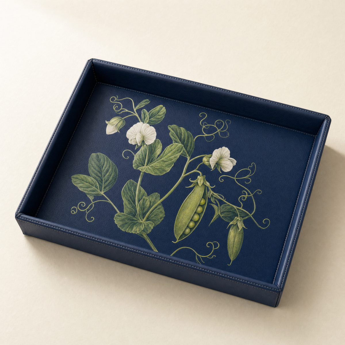 Navy faux leather serving tray with a botanical pea plant print on the base