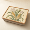 Wooden cushioned lap tray printed with a botanical study of a sweetcorn plant